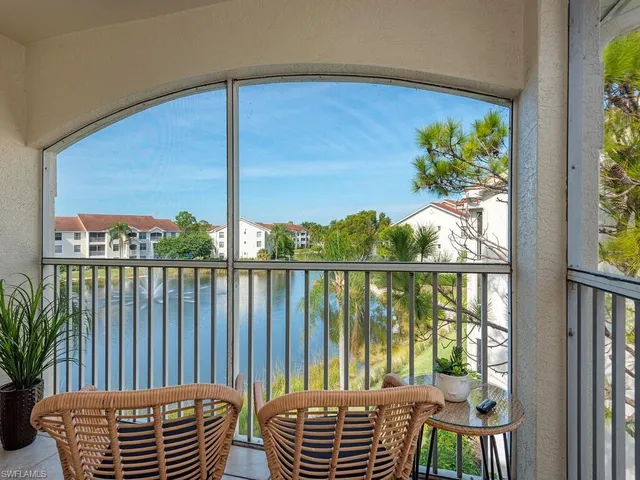 a view of residential houses with outdoor space and lake view