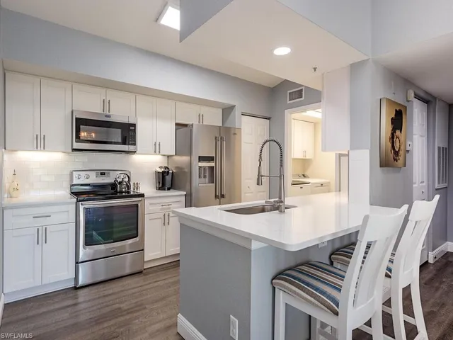 a kitchen with a stove a sink and a microwave
