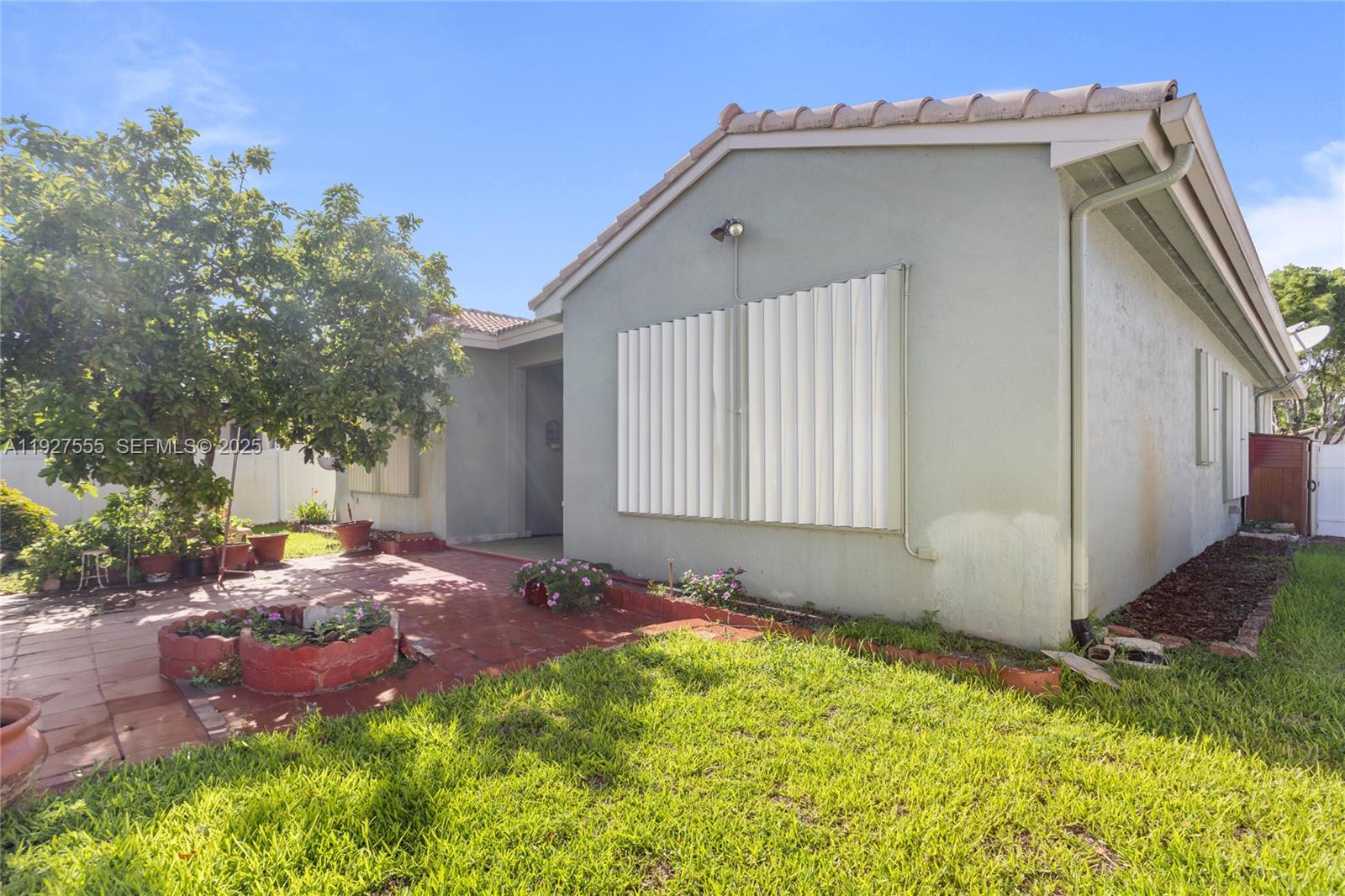 13148 Southwest 23rd Street Miramar, FL 33027 - Photo 22 of 24 a front view of a house with a yard
