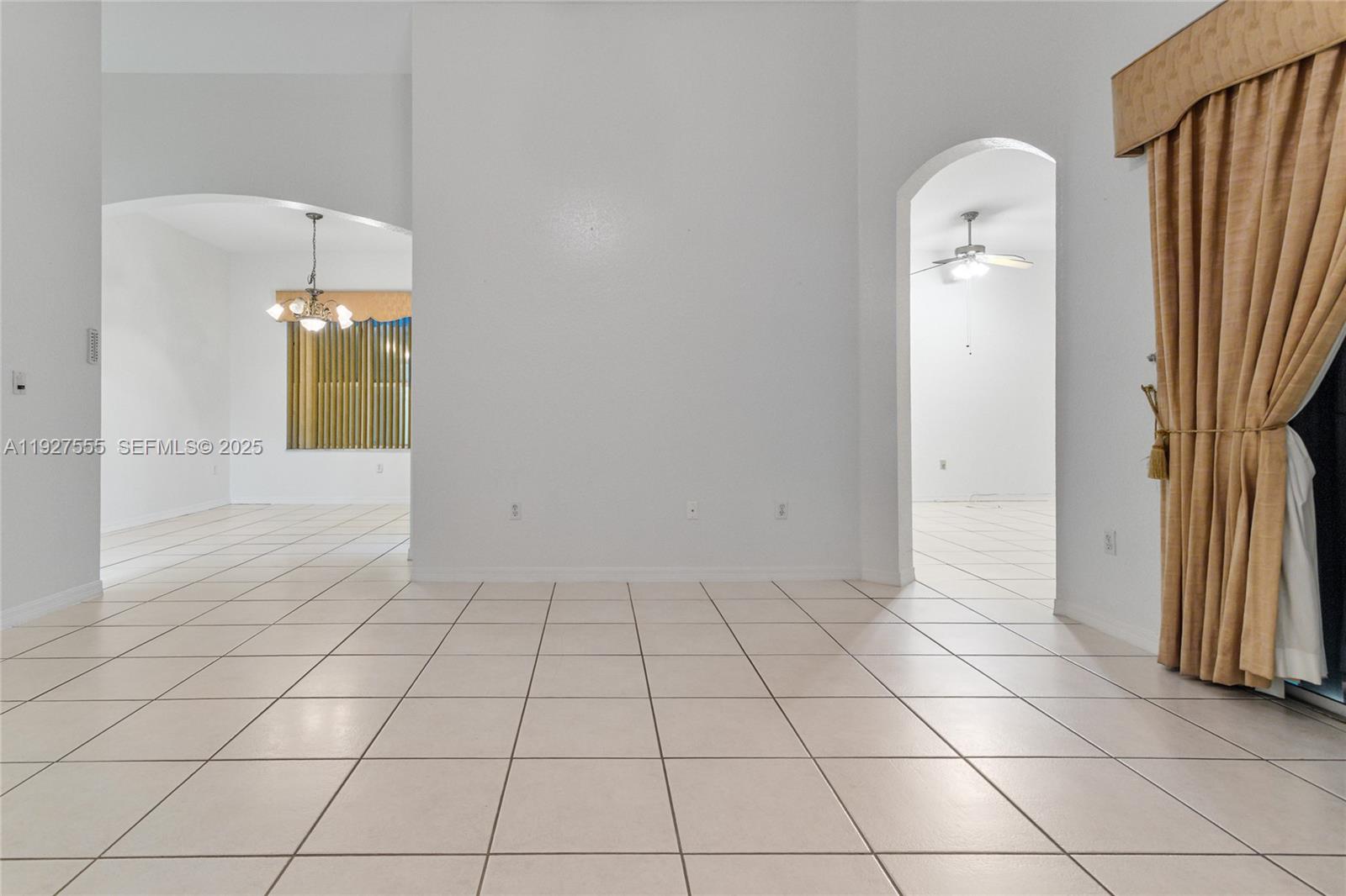13148 Southwest 23rd Street Miramar, FL 33027 - Photo 4 of 24 a view of a livingroom with wooden floor and a bathroom space