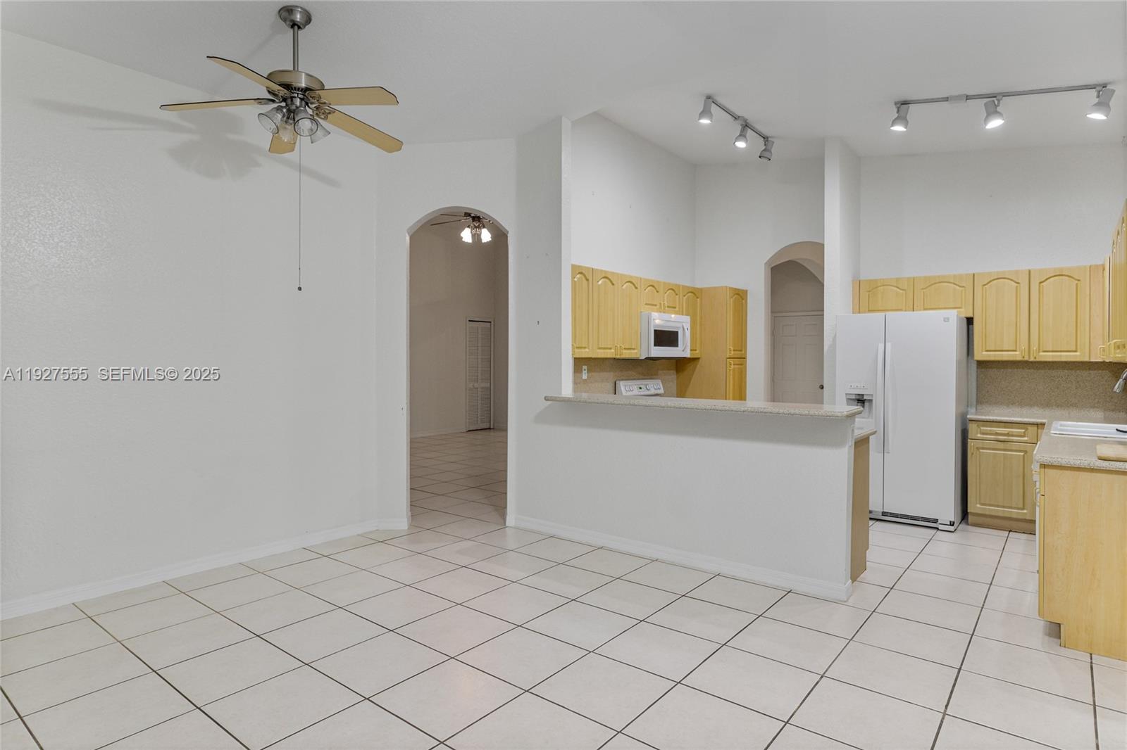 13148 Southwest 23rd Street Miramar, FL 33027 - Photo 8 of 24 a view of a kitchen with a refrigerator and a stove top oven
