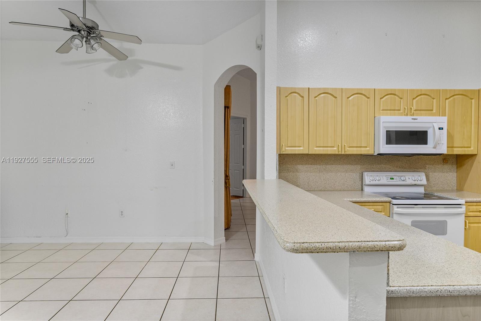 13148 Southwest 23rd Street Miramar, FL 33027 - Photo 10 of 24 a kitchen with stainless steel appliances granite countertop a sink a stove top oven and cabinets