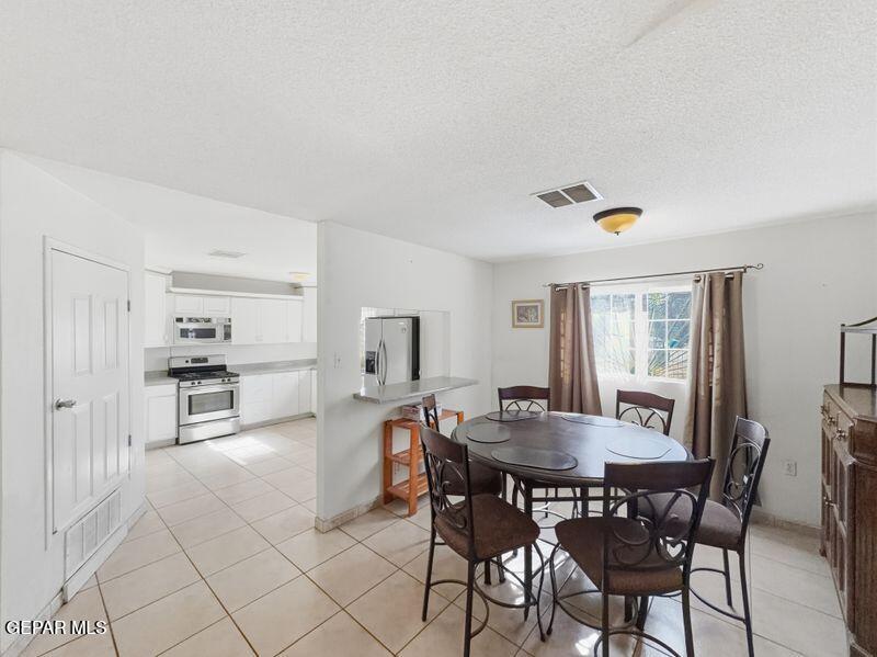 445 Suzi Way Socorro, TX 79927 - Photo 12 of 35 a view of a dining room with furniture and wooden floor