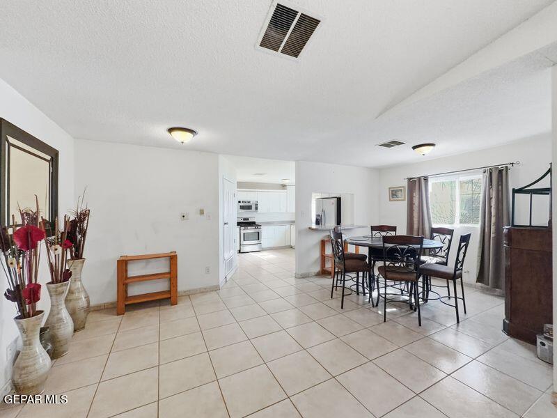 445 Suzi Way Socorro, TX 79927 - Photo 13 of 35 a dining room with furniture and a view of kitchen