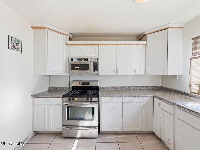 445 Suzi Way Socorro, TX 79927 - Photo 16 of 35 a kitchen with white cabinets and appliances