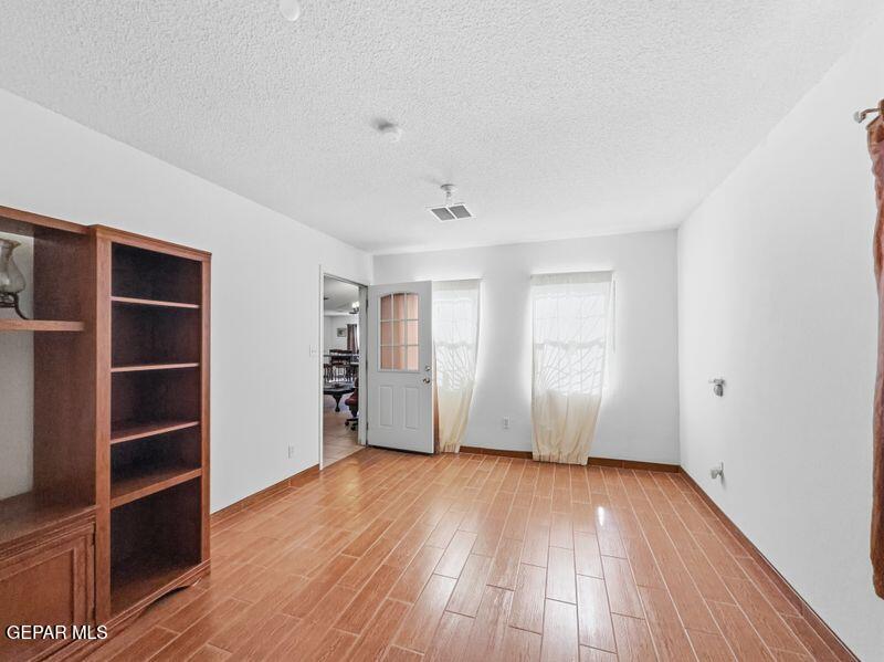 445 Suzi Way Socorro, TX 79927 - Photo 19 of 35 an empty room with wooden floor and closet