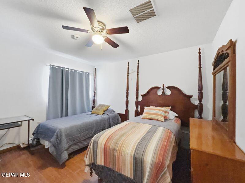 445 Suzi Way Socorro, TX 79927 - Photo 24 of 35 a bedroom with two beds and a chandelier