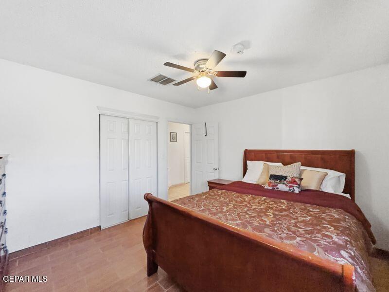 445 Suzi Way Socorro, TX 79927 - Photo 25 of 35 a bedroom with a bed and a ceiling fan
