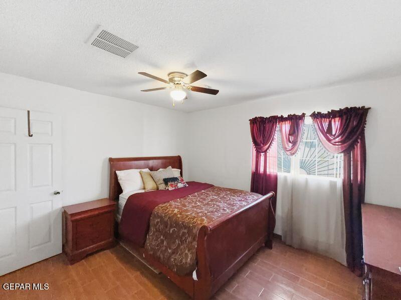 445 Suzi Way Socorro, TX 79927 - Photo 26 of 35 a bed room with a bed and a chandelier