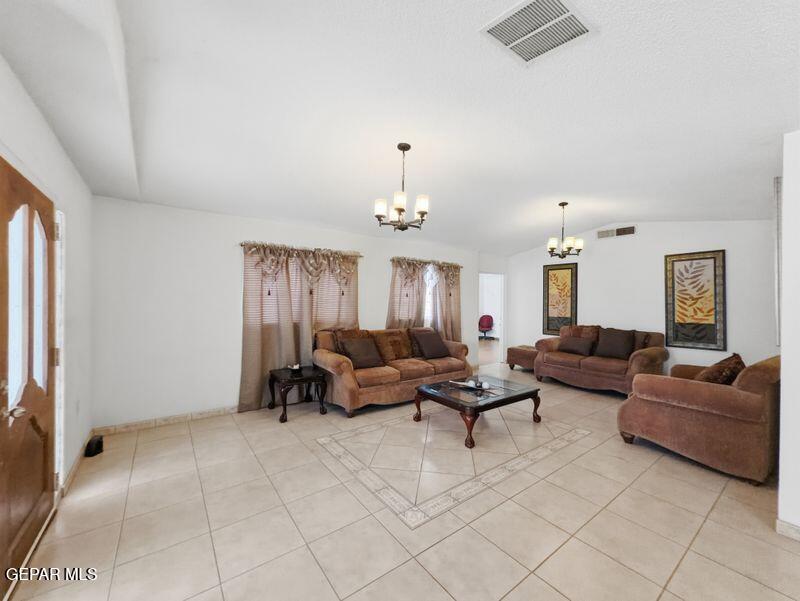445 Suzi Way Socorro, TX 79927 - Photo 8 of 35 a living room with furniture and a chandelier