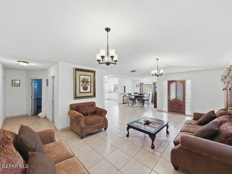 445 Suzi Way Socorro, TX 79927 - Photo 9 of 35 a living room with furniture and a chandelier