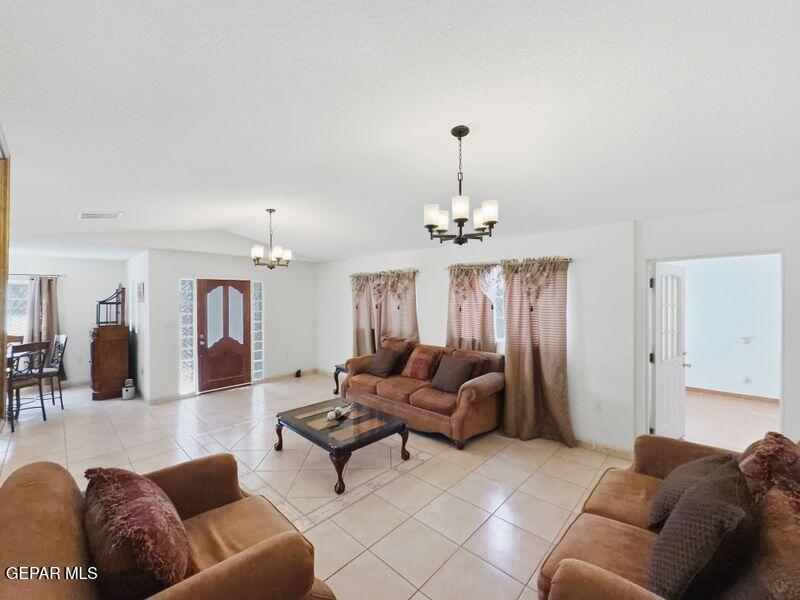 445 Suzi Way Socorro, TX 79927 - Photo 10 of 35 a living room with furniture and a chandelier