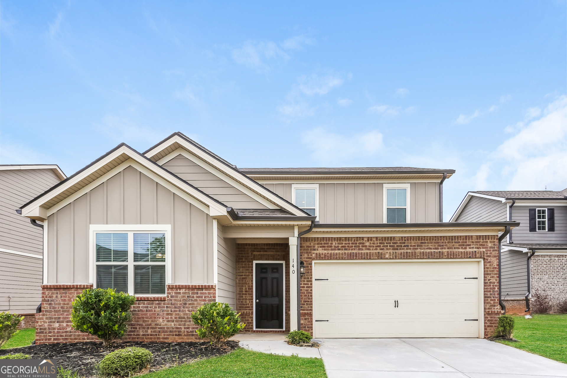 a view of house with yard and front view of a house