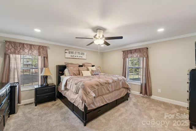 a bedroom with a bed and a large window