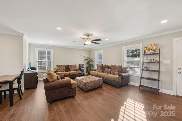 a living room with furniture and wooden floor