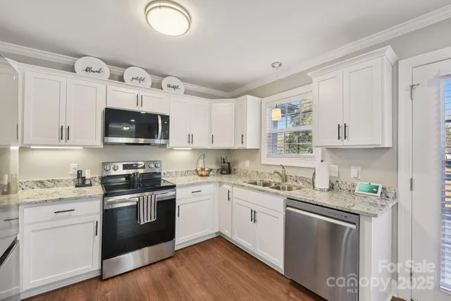 a kitchen with cabinets stainless steel appliances a sink and a counter space