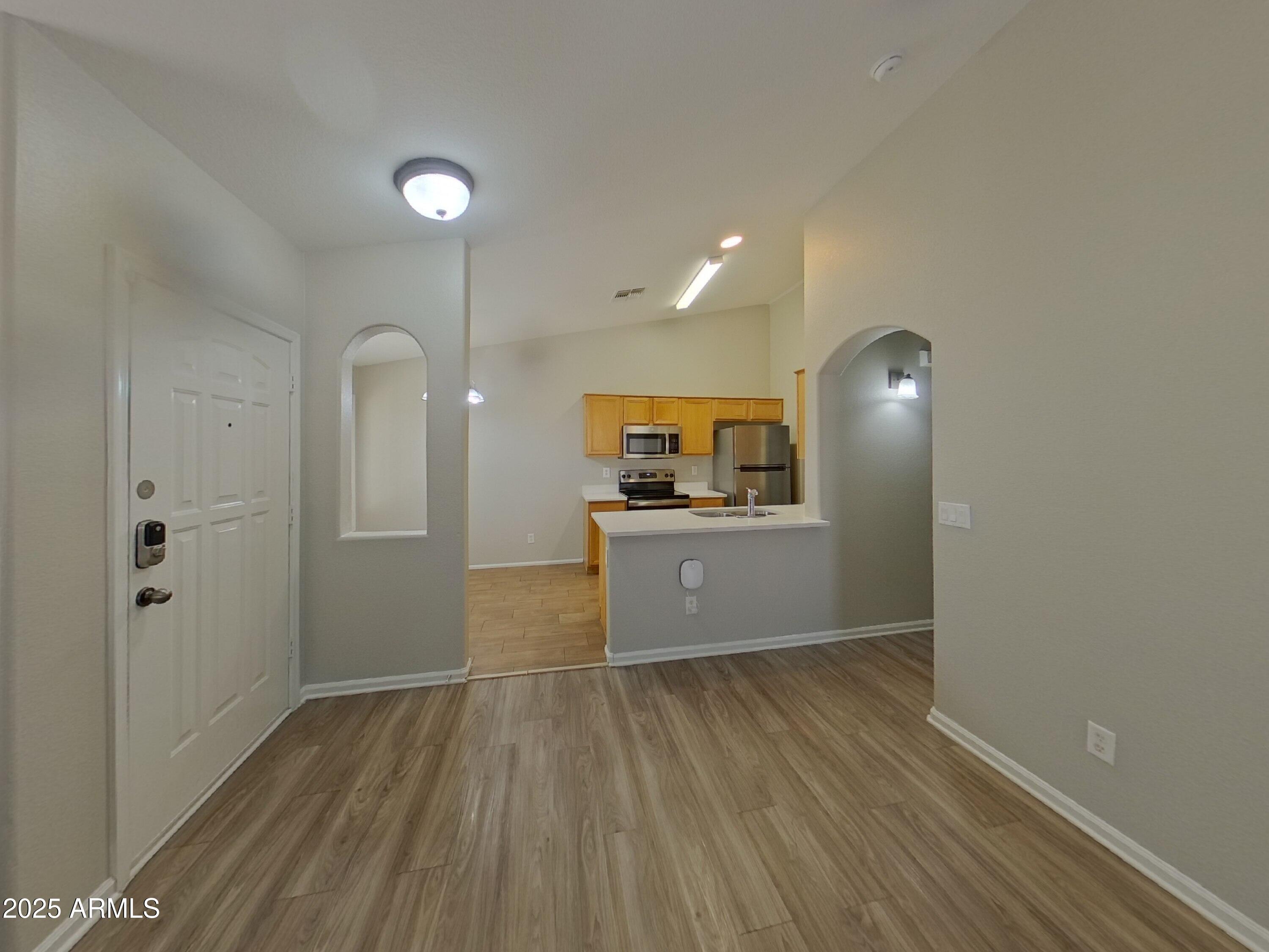 42396 Colby Drive Maricopa, AZ 85138 - Photo 2 of 17 a view of a kitchen from the hallway
