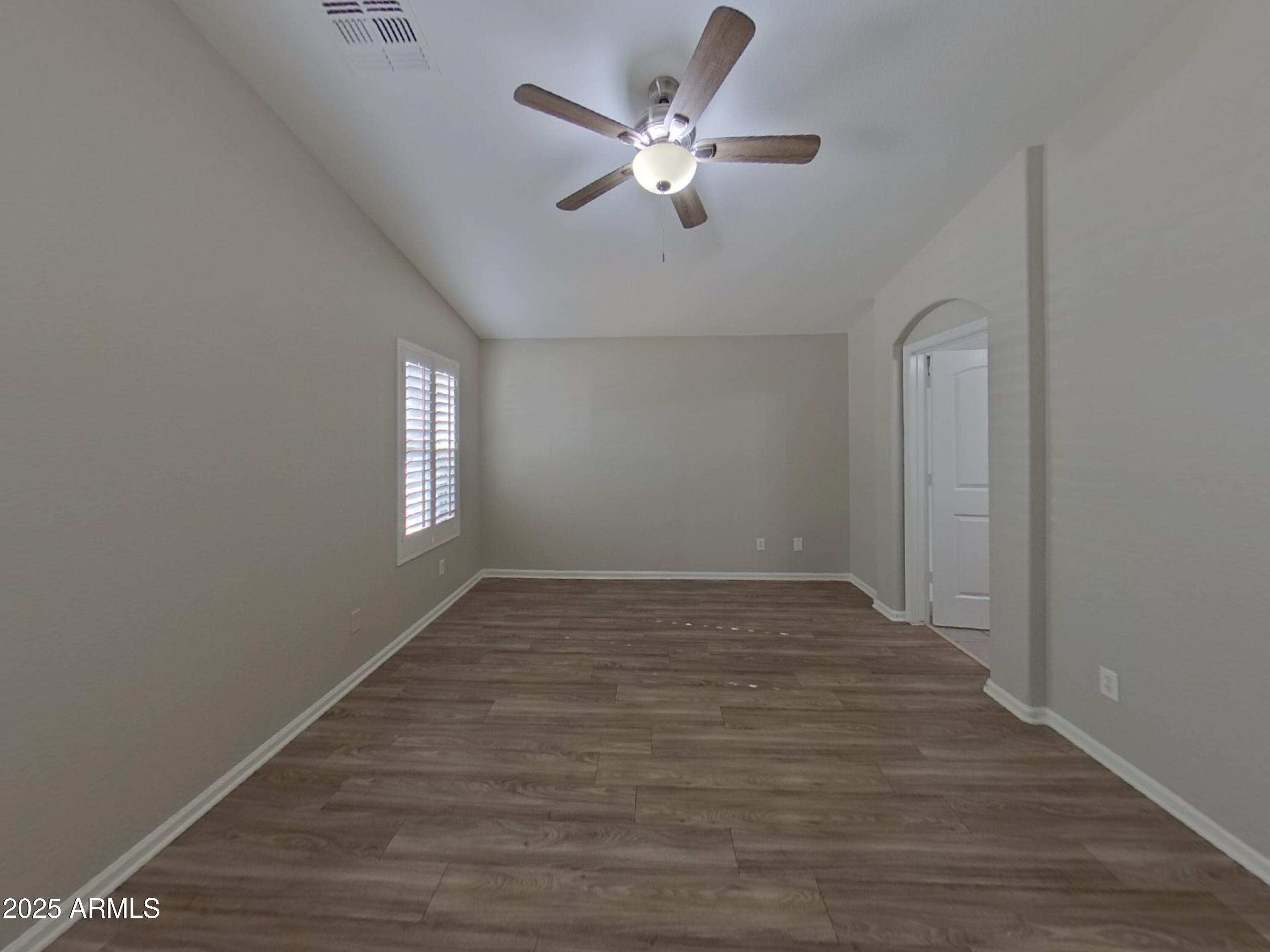 42396 Colby Drive Maricopa, AZ 85138 - Photo 6 of 17 wooden floor in an empty room with a window