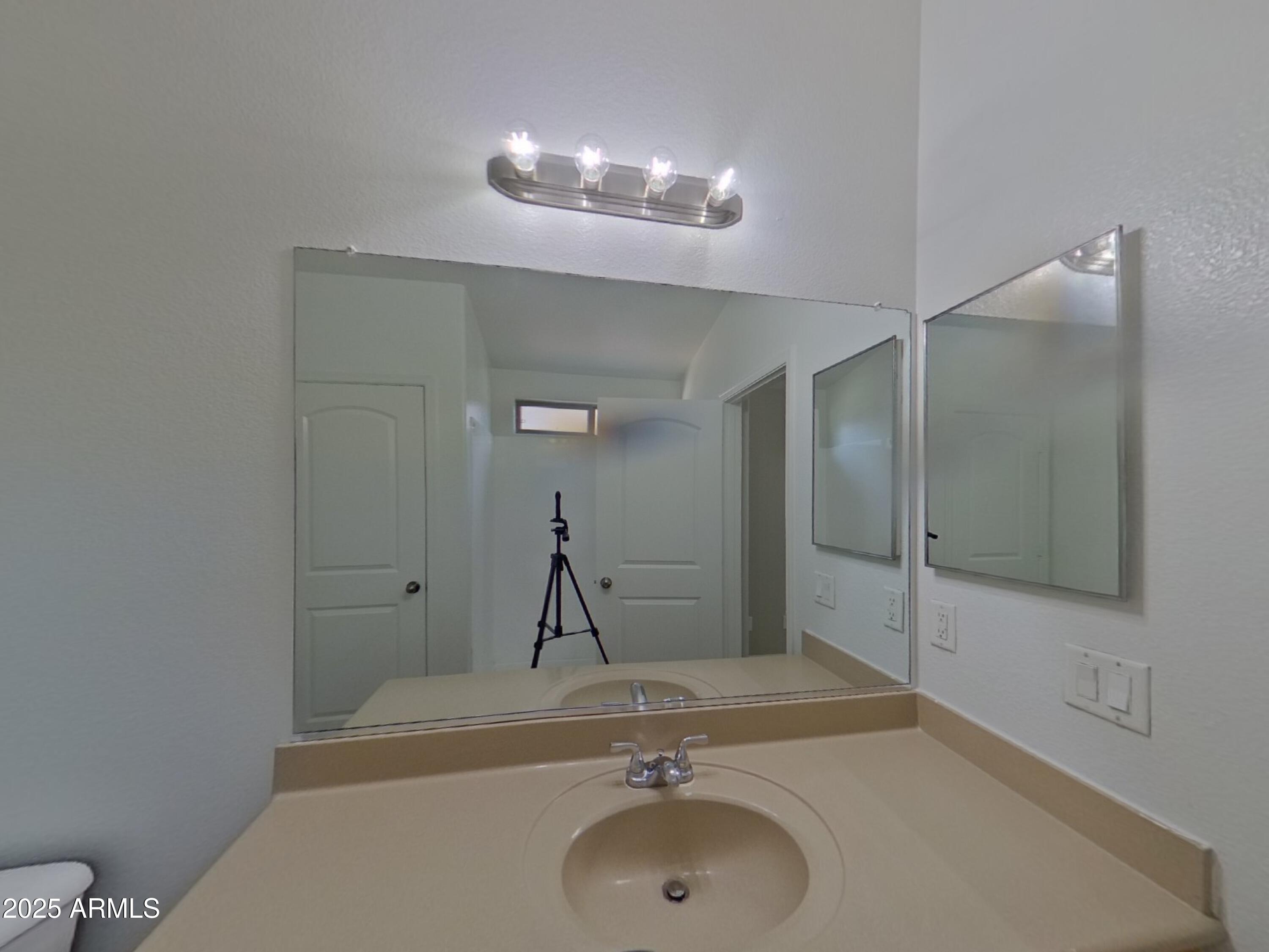 42396 Colby Drive Maricopa, AZ 85138 - Photo 8 of 17 a bathroom with a sink and a mirror