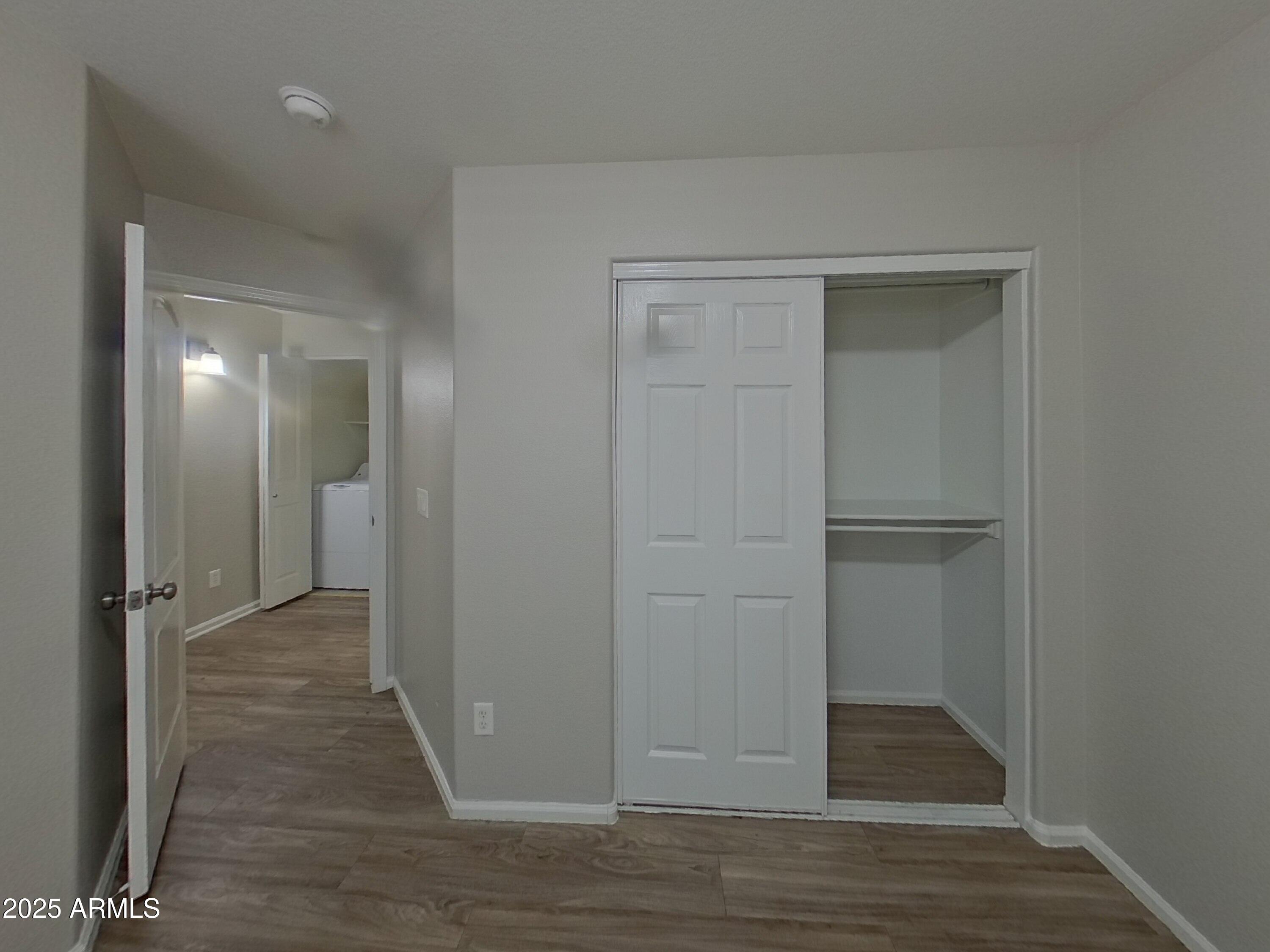 42396 Colby Drive Maricopa, AZ 85138 - Photo 9 of 17 a view of a hallway with wooden floor