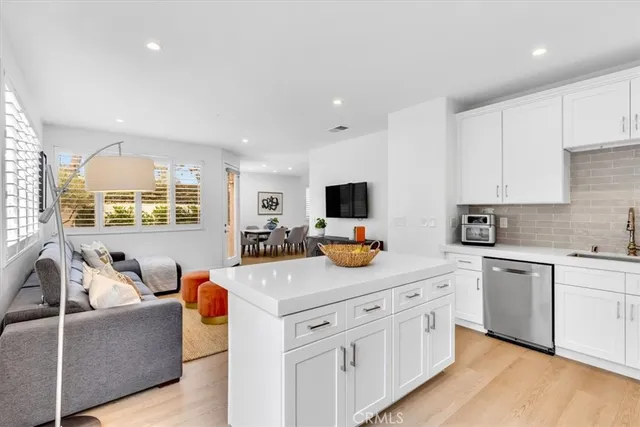 a view of kitchen with stainless steel appliances granite countertop a sink and a stove with wooden floor