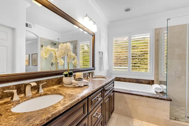 a bathroom with a granite countertop tub and a sink