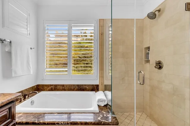 a bathroom with a tub and a shower