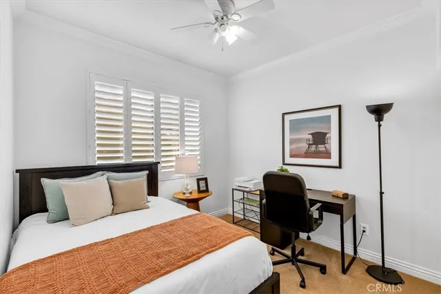 a bedroom with a bed and a desk