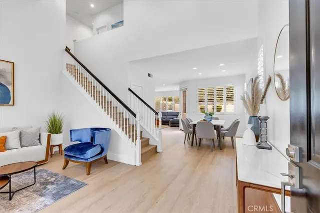 a living room with furniture a wooden floor and a flat screen tv