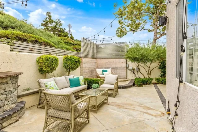 a view of a patio with couches and potted plants