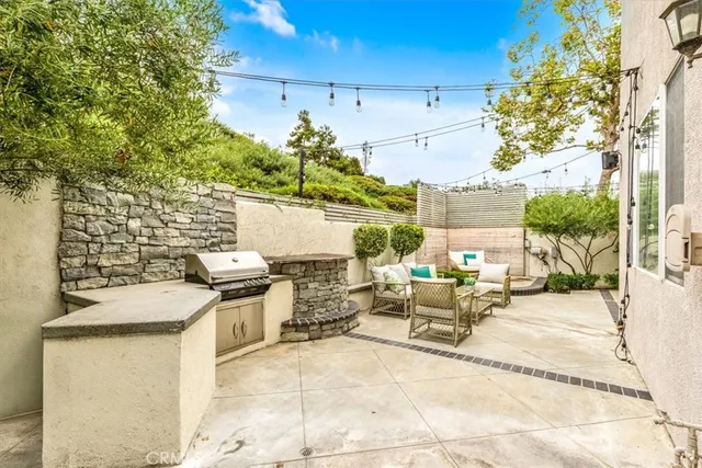 a view of a patio with table and chairs and potted plants