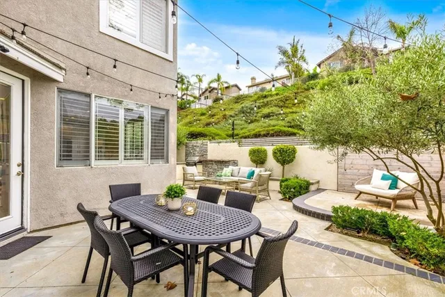 a view of a patio with table and chairs and potted plants