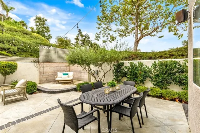 a view of a backyard with furniture and a garden