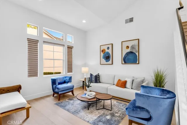 a living room with furniture and a potted plant
