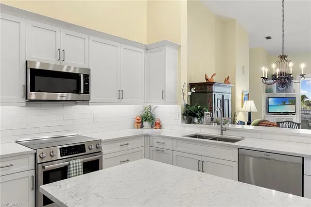 a kitchen with a sink stove and microwave