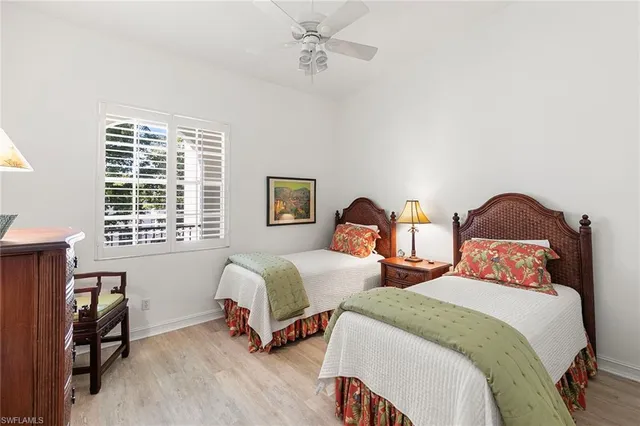 a bedroom with two beds and a window