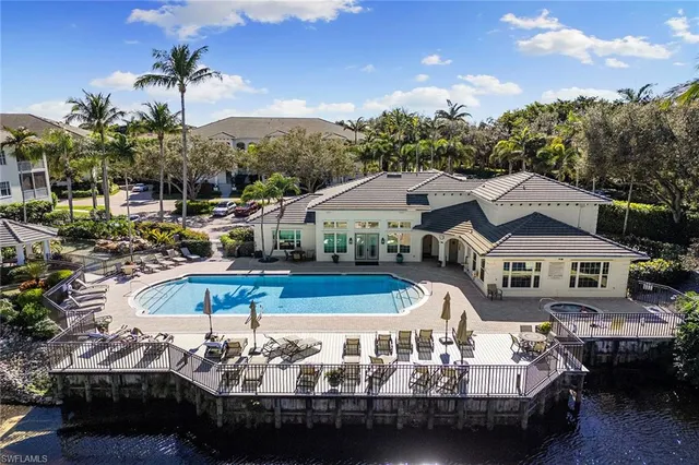 a view of a swimming pool with outdoor seating
