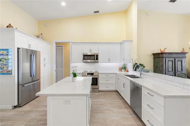 a kitchen with stainless steel appliances a refrigerator sink and stove