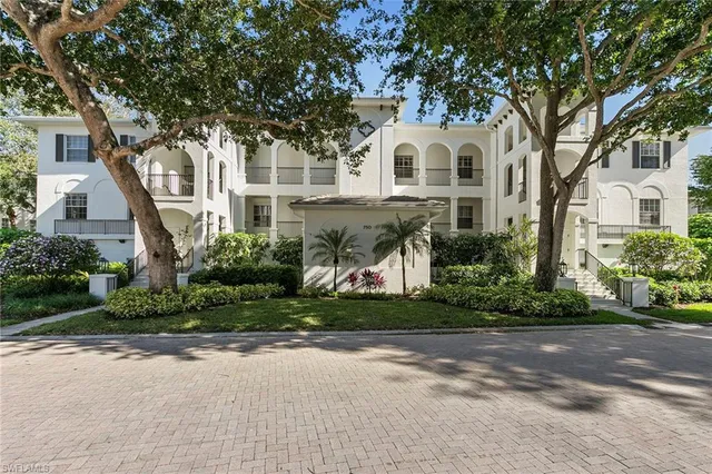 a view of white house with a yard and plants