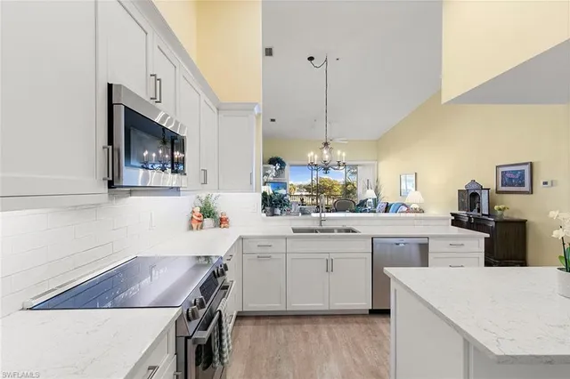 a kitchen with a sink a stove and cabinets