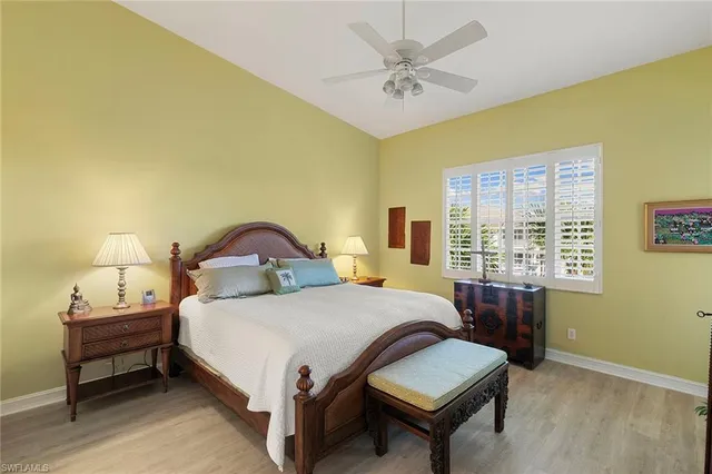 a bedroom with a bed lamp and a window