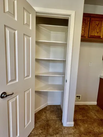 a view of walk in closet with empty racks
