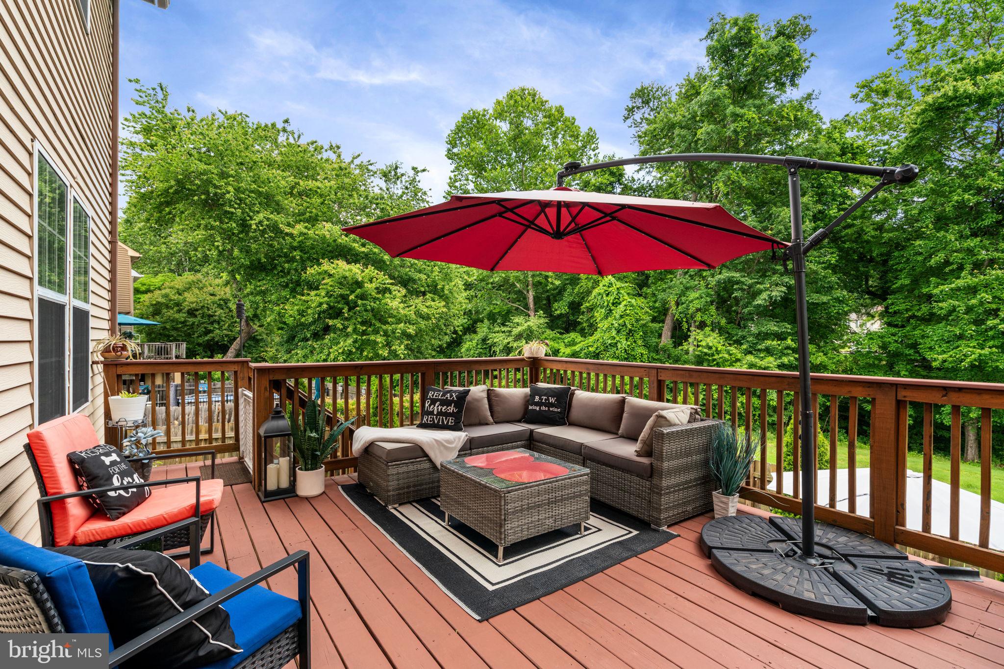 Beautiful deck looks out to wooded area.