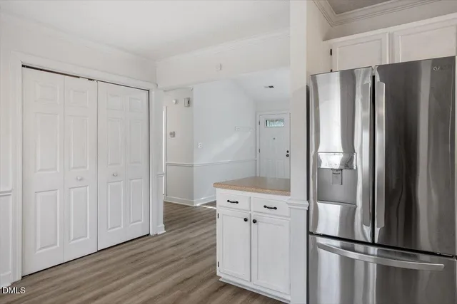 a kitchen with stainless steel appliances a refrigerator and cabinets