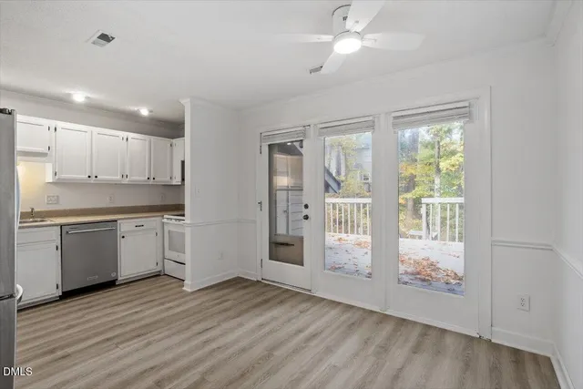 a kitchen with a refrigerator and a stove top oven
