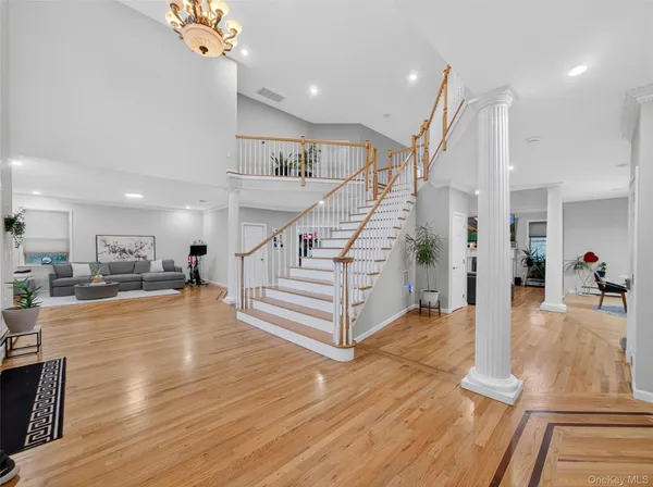 a view of entryway and hall with wooden floor