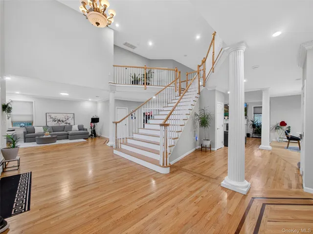 a view of entryway and hall with wooden floor