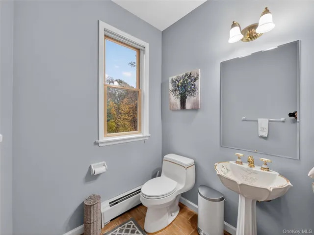 a bathroom with a toilet sink and mirror