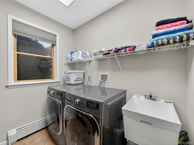 a utility room with a sink dryer and washer