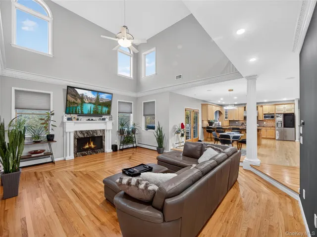 a living room with furniture a fireplace and a flat screen tv